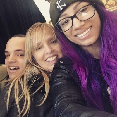All three are smiling as Sasha is taking the selfie.